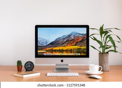 PHATTHALUNG, THAILAND - MARCH 24, 2018: IMac Monitor Computers, Keyboard And Magic Mouse, Coffee Cup, Cactus, Note Book, Tree Vase On Wooden Table, Created By Apple Inc.