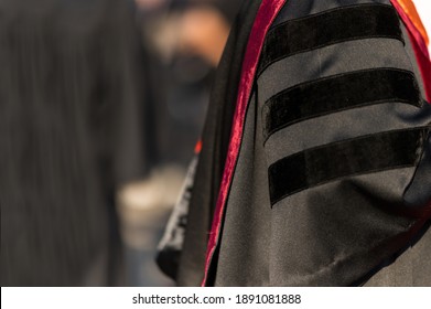 PhD graduate in black gown University degree