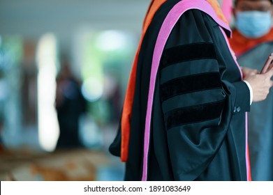 PhD graduate in black gown University degree