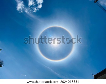 Phenomenon known as color ring  or halo sun with noise and grain 
