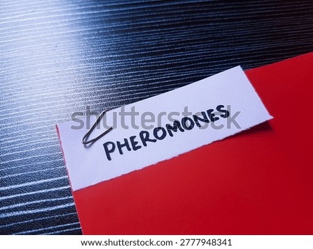 Pheromones writting on table background. 