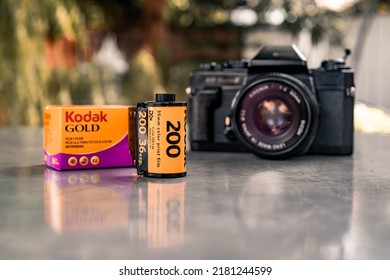 Phetchaburi, Thailand - July 17, 2022 : Kodak GOLD 200 ISO Film And Ricoh KR-5 Super II Camera, No Longer Manufactured With Film Canister On Marble Table.