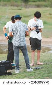 Phetchaburi, Thailand -July 9,2021:Behind The Scene. Film Crew Team Filming Movie Scene On Outdoor Location While Wearing Mask Prevent Covid-19 Or Coronavirus Quarantine Pandemic In Thailand.