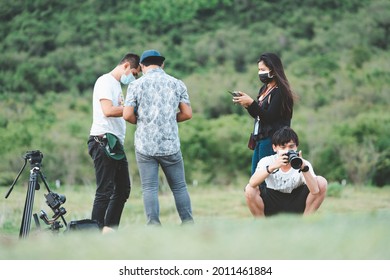 Phetchaburi, Thailand -July 9,2021:Behind The Scene. Film Crew Team Filming Movie Scene On Outdoor Location While Wearing Mask Prevent Covid-19 Or Coronavirus Quarantine Pandemic In Thailand.