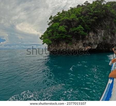 Phi Phi island off the coast of phuket thailand. Phi phi island is famous for turquoise clear blue waters teaming with Corel reef fish white soft sand and lush green trees.