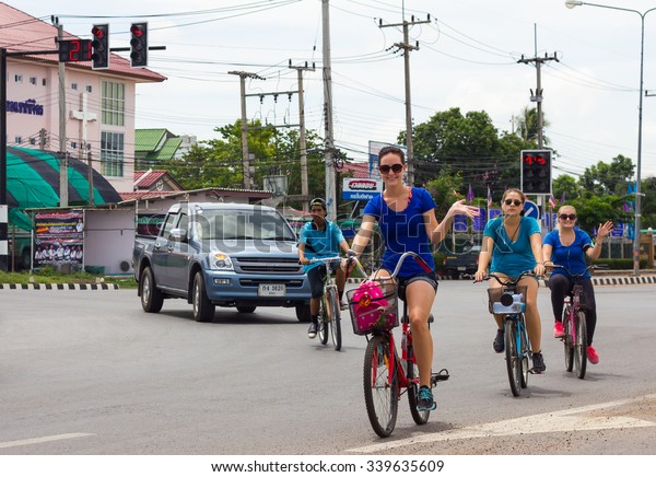 PHICHIT THAILAND-AUGUST\
19:\
Foreign women are happily cyclists to cross the road\
intersection \
to the events in Thailand.On August 19, 2015 in\
Phichit, Thailand.