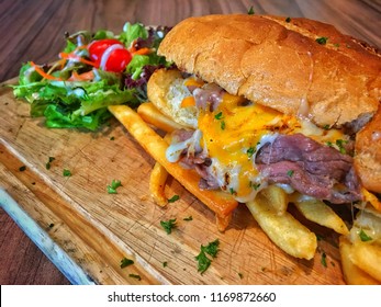 Philadelphia Cheesesteak, Philly Cheesesteak, Cheesesteak Sandwich, Cheese Steak, Or Steak And Cheese, Is A Sandwich Made From Thinly Sliced Pieces Of Beefsteak And Melted Cheese In A Long Hoagie Roll