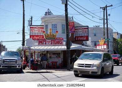 Philadelphia, PA - May 2022: People Go About Their Daily Routines In Front Of Pat's King Of Steaks