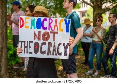 Philadelphia, PA USA 06-25-2022 Woman Holds A Feminist Sign At A Crowded Pro-choice Women's Reproductive Freedom Political Rally. Sign Reads, DEMOCRACY NOT THEOCRACY. Josh Shapiro Rally. 