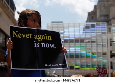 Philadelphia, PA / USA - July 12, 2019: A Young Girl Holds Up A Protest Sign To Demand The Closure Of Detention Camps At The U.S.-Mexico Border.