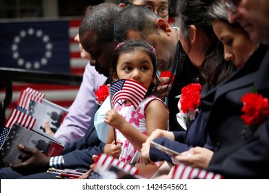 Philadelphia, PA / USA - June 14, 2019: The Daughter Of A Immigrant Holds An American Flag While She Joins Her Mother's Naturalization Ceremony On Flag Day At The Historic Betsy Ross House.