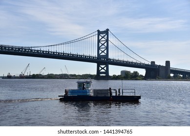 PHILADELPHIA, PENNSYLVANIA, USA: JUNE 26, 2019: A Philadelphia Water Department barge is cleaning trash from the Delaware River