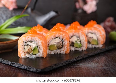 Philadelphia roll sushi with salmon, smoked eel, cucumber, avocado, cream cheese, red caviar. Sushi menu. Japanese food. 