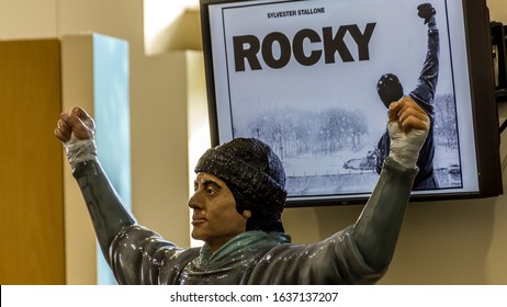 Philadelphia, United States of America - September 2014: A german photographer visiting Philadelphia, taking pictures of a statue of Rocky Balboa inside a building. 
