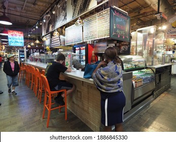 Philadelphia, USA - June 11, 2019: People Hanging Around, Drinking And Eating In The Reading Terminal Market In Philadelphia.