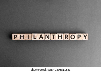 Philanthropy - Word From Wooden Blocks With Letters, To Help Poor People Altruism Charity Philanthropy Concept,  Top View On Grey Background