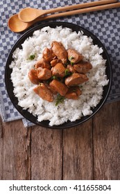 Philippine Adobo chicken with rice on a plate vertical view from above
