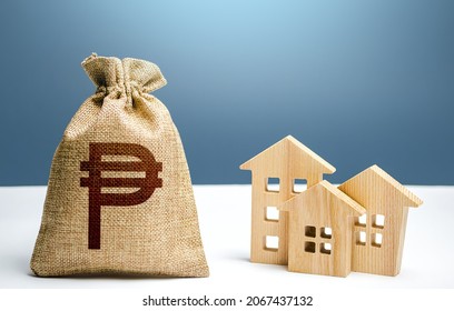Philippine peso money bag and residential buildings. City municipal budget. Property tax. Investment in real estate. Costs of service and maintaining. Purchase of housing. Mortgage loan.
