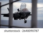 PHILIPPINE SEA (May 22, 2025) An F-35B fighter aircraft from Marine Fighter Attack Squadron prepares to land on the flight deck of the forward-deployed amphibious assault ship USS America, May 22.