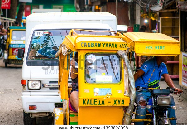 PHILIPPINES,\
BORACAY ISLAND- January 1, 2019: taxi tricycle moving in traffic on\
philippine city street. Asian\
transport