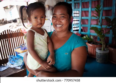 PHILIPPINES - June, 2013: Smiling Filipino woman with a child on her hands, Philippines. Filipino people portrait.
