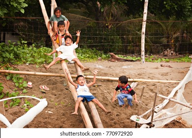 PHILIPPINES - June 2015: Cute Filipino kids having fun on the beach. Filipino children playing on the beach, Palawan, Philippines