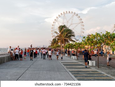 Philippines, Metro Manila, Pasay, 28 August 2017 - People Walking Around At SM Mall Of Asia Bay Area