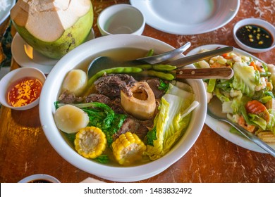 Philippines traditional dinner with bulalo beef marrow bones and vegetables