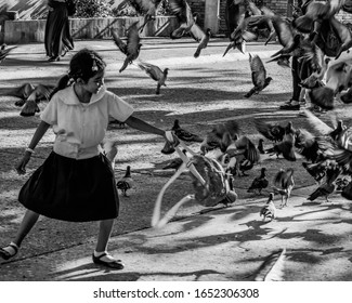 PHILIPPINES, ZAMBOANGA CITY - February 18, 2020: Unidentified Little Girl Loves To Play With Birds In Fort Pilar Shrine.