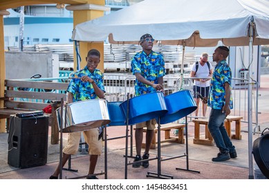 PHILIPSBURG, ST. MARTIN/DUTCH WEST INDIES - JANUARY 31, 2019: Photo of a steel drum/pan band playing upbeat music for cruise ship visitors in the harbor area.  