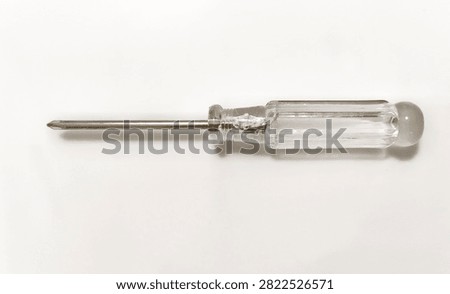 Phillips head screwdriver with a transparent plastic handle isolated on a white background. Essential hand tool for tightening and loosening slotted screws, ideal for home repairs, maintenance, construction, electrical work, and DIY projects.