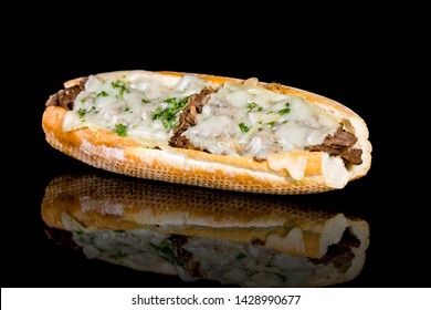 Philly cheese steak baguette with reflection isolated on black background. Studio Shot