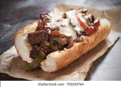 Philly cheese steak sandwich served on parchment paper