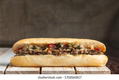 Philly cheese steak with steam on wooden surface