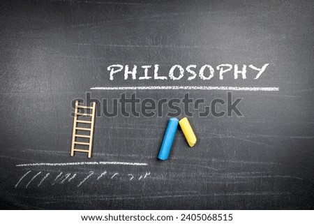 Philosophy Concept. Text and pieces of chalk on a dark chalkboard background.