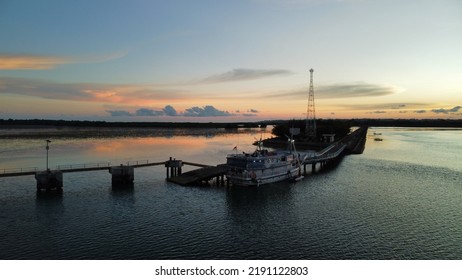 A Phinisi Ship Is Docked In The Harbor.