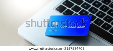 Phishing attack. Credit card catch by fish hook close-up detail on coputer keyboard. Credit card fraud data leak money stealing pishing concept.