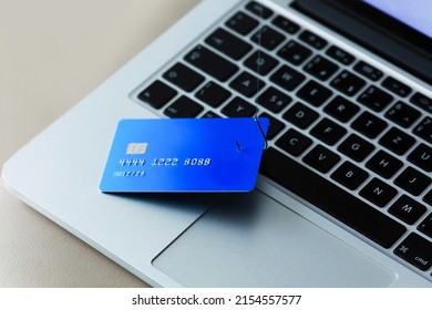 Phishing Credit Cards - Piles of credit cards with fish hook on computer keyboard. Dark cyber attack concept. Background.