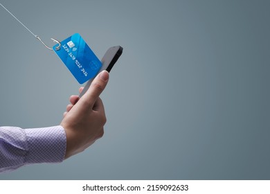 Phishing and cyber security: hacker stealing a user's credit card information on a smartphone