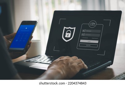 phishing scam, mobile phone hacker, or cyber scam concept. Password and login passcode in the smartphone. Online security threat and fraud. a scammer with cell phone and laptop. Bank account security. - Shutterstock ID 2204374843