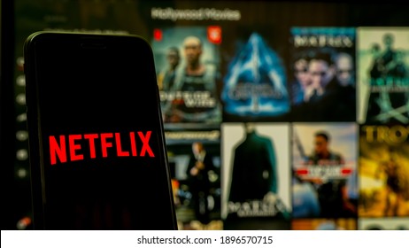 Phitsanulok Thailand - January 17, 2021: 
Hand holding martphone with logo Netflix on iphone.
Application Netflix international service provider of streaming TV series and movies. 