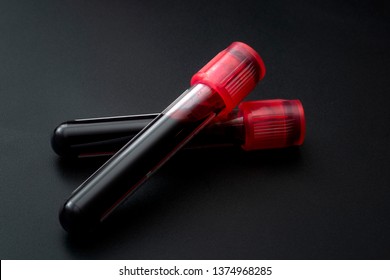 Phlebotomy, biochemical analysis, laboratory exam and blood testing concept theme with two test tubes isolated on black background