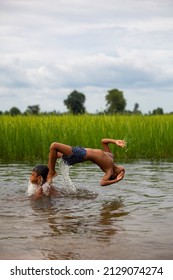 Phnom Phenh City , Cambodia. 2,5,2021 :Two Boys Swimming In The Field .