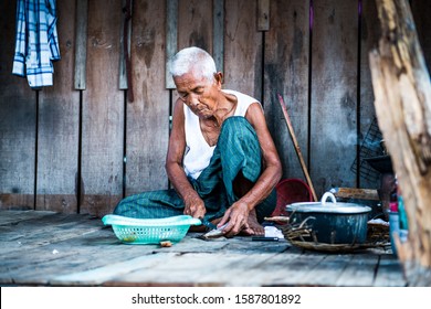 Phnom-pen, Island Koh Dach, Cambodia, 14.11.2013,  Elderly Lady With Silver Hair, Lives Alone And Is Cooking Her Lunch In-front Of Her Hut 