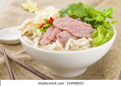 Pho Bo - Vietnamese Fresh Rice Noodle Soup With Beef, Herbs And Chili. Vietnam's National Dish.
