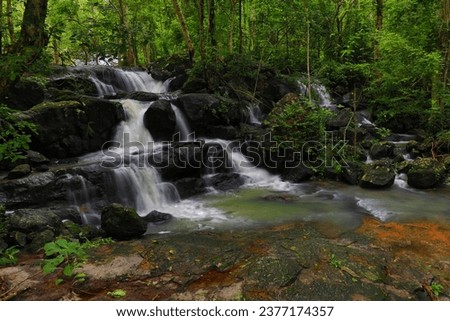 Pho Hin Dat waterfall,there was a widestone courtyard and a sprawling tree.The surrounding forests are abundant.
Namtok Sam Lan national park, Saraburi Province,Thailand 