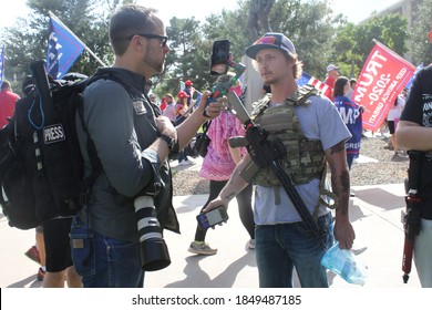 Phoenix, Ariz. / USA - November 7, 2020: A reporter interviews an armed Trump supporter who's at Arizona Capitol building to protest the results of the 2020 presidential election. 2478