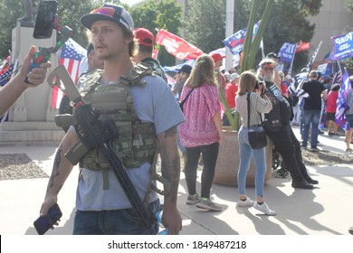 Phoenix, Ariz. / USA - November 7, 2020: With guns, flags and Bible verses, Trump supporters circle the Arizona Capitol building to protest the results of the 2020 presidential election. 2484