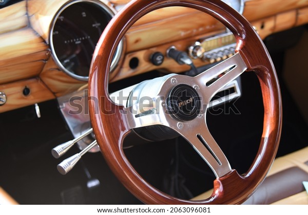 Phoenix Arizona 10-23-2021 Wooden\
steering wheel and interior of a vintage car with Pilot\
logo