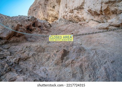 Phoenix, Arizona- Sign hanging on a chainlink against the rock mountain wall at Camelback Mountain. Yellow sign with Closed Area Do Not Enter. - Shutterstock ID 2217724315